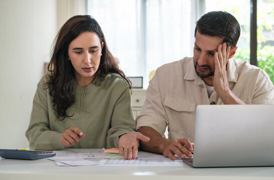 Couple facing overdue bills and financial pressure at home, stressed by inflation and economy recession