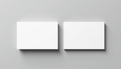 Fototapeta premium Two Blank White Business Card Stacks Mockup on Gray Background