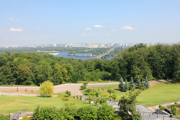 Panoramic view of Kyiv and Dnipro river with bridge and green park in summer