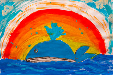 Whale in ocean under rainbow made by child using watercolor painting