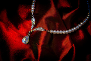 pearl necklace on red silk