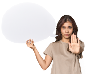 Middle Eastern woman holding comic bubble standing with outstretched hand showing stop sign, preventing you.