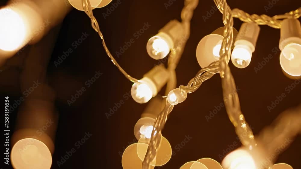 Poster close-up video of intertwined fairy lights with a bokeh effect, creating a dreamy, abstract atmosphe