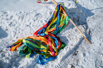 Colorful, vibrant ribbons are beautifully laid atop the pristine, untouched snow, creating a...