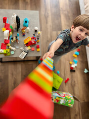 Happy Child Playing with Colorful Building Blocks