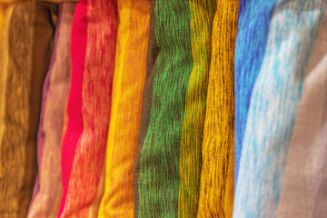 Closeup view of colorful fabrics woven in row. Fez. Morocco. Horizontally.