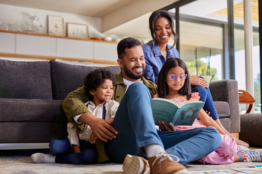 Indian father reading a story to his children at home