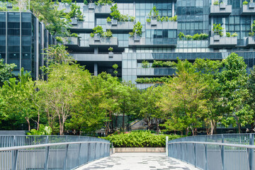 Modern eco-friendly architecture with vertical garden and greenery surrounding office glass...