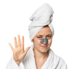 Young Caucasian redhead with pore strip smiling cheerful showing number five with fingers.