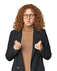 Young Caucasian redhead in business attire showing that she has no money.