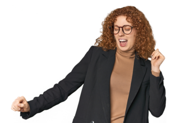 Young Caucasian redhead in business attire dancing and having fun.