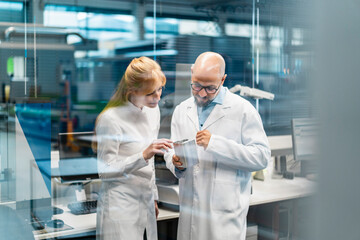 Scientists discussing research in a laboratory setting