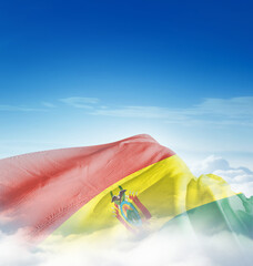 Bolivia national flag waving in the clouds. The flag hiding in blue sky. Bolivia national flag for...