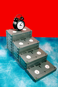 Stack of VHS tapes with an alarm clock in a pop art style
