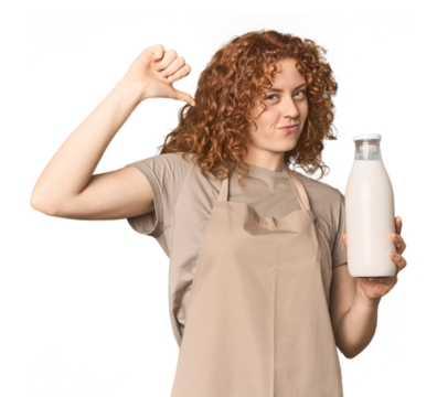 Young Caucasian redhead woman with milk feels proud and self confident, example to follow.