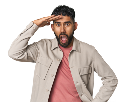 Young Hispanic man isolated shouts loud, keeps eyes opened and hands tense.