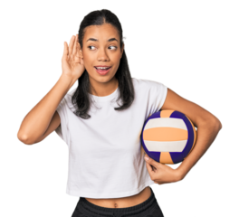 Young Filipino woman with volleyball trying to listening a gossip.