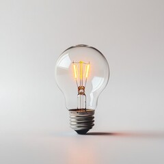 Glowing Light Bulb Close-up on White Background Representing Innovation and Ideas