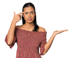 Young Filipino woman in studio holding and showing a product on hand.