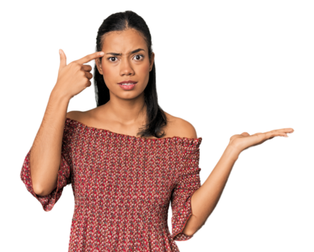 Young Filipino woman in studio holding and showing a product on hand.