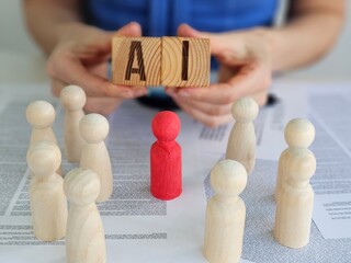 Wooden figures surrounding red piece and wooden blocks with AI symbol during discussion on...