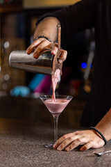Bartender preparing alcohol cocktail in a glass