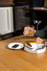 Close up of man hands holding whiskey glass