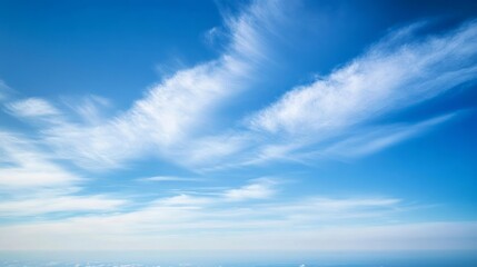 Obraz premium Vast blue sky adorned with delicate clouds, evoking serenity and boundless freedom. 