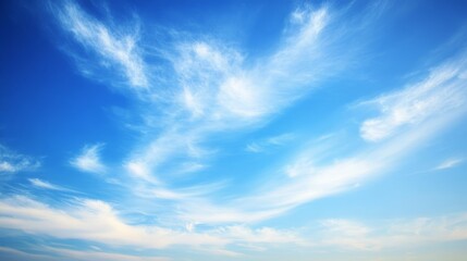 Fototapeta premium Vast blue sky adorned with delicate clouds, evoking serenity and boundless freedom. 