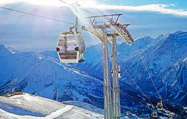 designer comfortable cabins in the ski lift on the slope of the italian resort in the alps