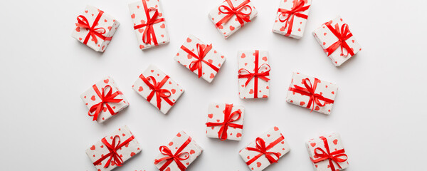 Valentine day composition Background: red gift box with bow and heart. Christmas present. View from above. Holday greeting card