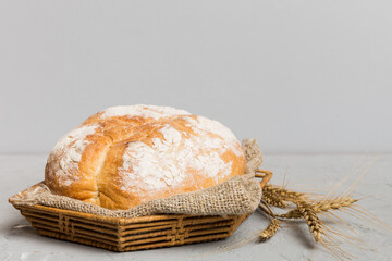 Freshly baked bread on basket against natural background. Perspective view bread copy space