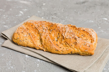 freshly baked bread with napkin on rustic table top view. Healthy white bread loaf isolated