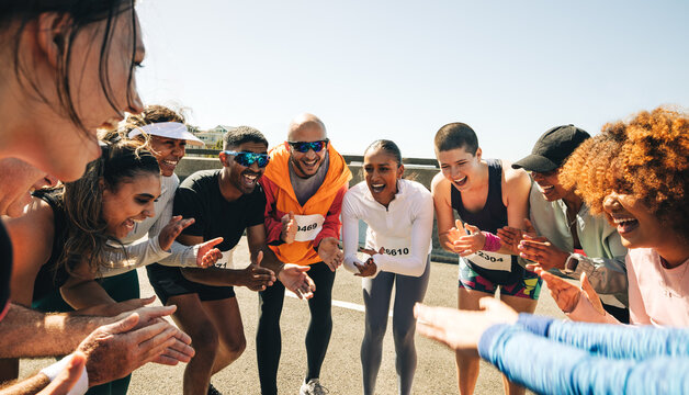 Group of friends cheering and clapping at marathon event