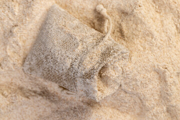 wheat flour with bran in a linen bag, fresh wheat flour close-up, flour for making bread with bran, closeup