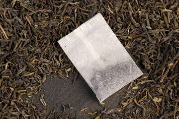 tea and packaged tea, high quality expensive green tea and a white bag with one cheap tea close up