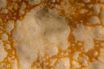 the details of the pancake that was fried in an uneven abstract pattern