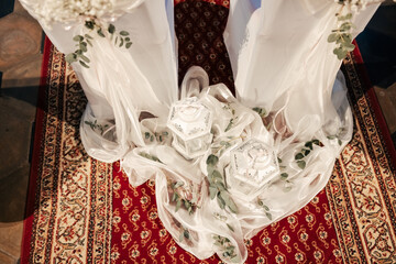 Gracefully adorned with ribbons and blooms, the church whispers elegance. Each detail adds a touch of romance to the sacred space where vows will soon be exchanged.