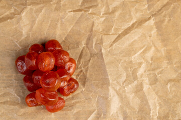 dried fruits are gathered in a pile on the edge of the paper, top view