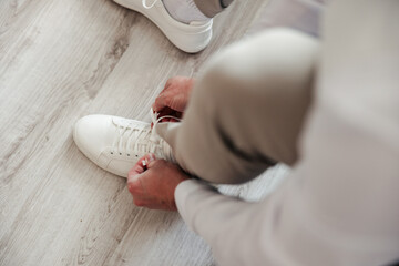 With focused hands and a steady heart, he ties his shoes — a final step before becoming her...