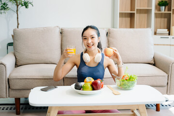 Woman enjoys a fresh salad with fruits and juice, embodying wellness, nutrition, and vitality