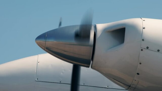 Close-up view of rotating propeller engine of twin turbo light airplane. Side view of spinning blades