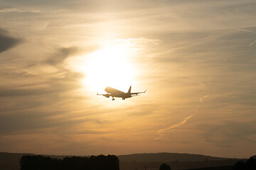 Stunning Backlit View of Incoming Airplane