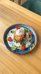 Zucchini fritters, red fish, salmon, poached egg. A restaurant dish.