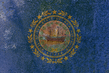 New Hampshire State Flag. Dirty New Hampshire state flag on rusty metal surface.
