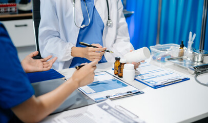 Doctors and nurses review medical paperwork and prescriptions in a professional healthcare setting....