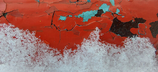Weathered red surface with ice and corrosion layers, combining natural elements and urban decay...