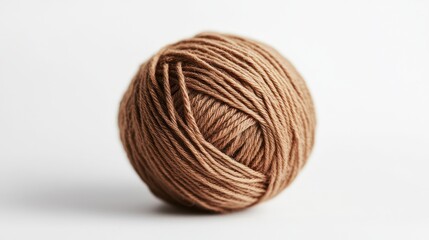 Beige yarn ball on white background; crafting supply; close-up; for knitting projects