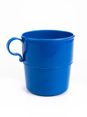 Empty blue plastic cup or mug with handle isolated on white