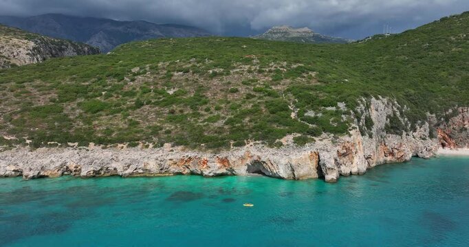 Canyon of Gjipe with Ionian Sea during the day in Vlore County, Albania, pan aerial drone shot